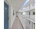 Clean and well-lit hallway with blue door at 19610 Gulf Blvd # 303, Indian Shores, FL 33785