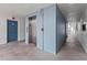 Clean hallway with elevator access and blue walls at 19610 Gulf Blvd # 303, Indian Shores, FL 33785