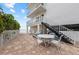 Small patio area with table and chairs, near beach access at 19610 Gulf Blvd # 303, Indian Shores, FL 33785