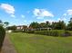 Landscaped backyard with spacious lawn and a pergola at 1981 Bayshore Dr, Englewood, FL 34223