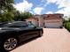 Black electric car parked in front of a two-story house at 1981 Bayshore Dr, Englewood, FL 34223