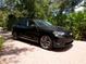 Black electric car parked on a brick driveway at 1981 Bayshore Dr, Englewood, FL 34223