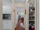 Hallway with wood floors and access to kitchen and dining areas at 1981 Bayshore Dr, Englewood, FL 34223