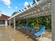 Poolside patio with pergola and lounge chairs at 1981 Bayshore Dr, Englewood, FL 34223