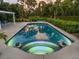 Relaxing pool and spa with tranquil nighttime lighting at 1981 Bayshore Dr, Englewood, FL 34223