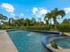 Inviting pool with spa and lush landscaping at 1981 Bayshore Dr, Englewood, FL 34223