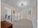 Spacious upstairs hallway with carpeting, offering access to bedrooms and a bonus area at 1981 Bayshore Dr, Englewood, FL 34223