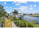 Backyard with canal view and yellow chairs at 210 Beeney Se Rd, Port Charlotte, FL 33952