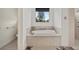 Bathroom with a large soaking tub and window at 210 Beeney Se Rd, Port Charlotte, FL 33952