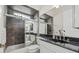 Bathroom with dark tiled shower and granite countertop at 210 Beeney Se Rd, Port Charlotte, FL 33952