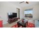 Bonus room with TV, balcony access and comfortable seating at 210 Beeney Se Rd, Port Charlotte, FL 33952