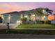 Stunning house exterior at dusk with a three car garage at 210 Beeney Se Rd, Port Charlotte, FL 33952