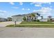 House exterior featuring a two-car garage and manicured lawn at 210 Beeney Se Rd, Port Charlotte, FL 33952