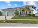 Two-story home with three-car garage and manicured lawn at 210 Beeney Se Rd, Port Charlotte, FL 33952