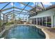 Enclosed pool and spa with patio furniture at 210 Beeney Se Rd, Port Charlotte, FL 33952