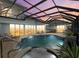 Enclosed pool and spa with patio furniture at 210 Beeney Se Rd, Port Charlotte, FL 33952