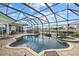 Enclosed pool and spa with patio furniture at 210 Beeney Se Rd, Port Charlotte, FL 33952