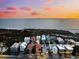 Beachfront property aerial view at sunset, showcasing the home and neighborhood at 221 Tenacity Ln, Sarasota, FL 34242