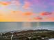 Aerial view of beach and shoreline at sunset at 221 Tenacity Ln, Sarasota, FL 34242