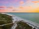 Aerial view of beach and shoreline at sunset at 221 Tenacity Ln, Sarasota, FL 34242