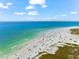 Aerial view of beach with people and water at 221 Tenacity Ln, Sarasota, FL 34242