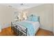 Bright bedroom with hardwood floors and a metal bed frame at 221 Tenacity Ln, Sarasota, FL 34242