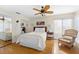 Bedroom with a ceiling fan and wicker chair near the window at 221 Tenacity Ln, Sarasota, FL 34242