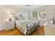 Light and bright bedroom with hardwood floors and a metal bed frame at 221 Tenacity Ln, Sarasota, FL 34242