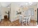 Charming dining room with white table and chairs, and chandelier at 221 Tenacity Ln, Sarasota, FL 34242