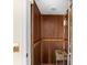 Private elevator with wood paneling and mosaic table at 221 Tenacity Ln, Sarasota, FL 34242