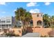 Exterior of beach home with palm trees and two-car garage at 221 Tenacity Ln, Sarasota, FL 34242