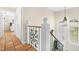 Upstairs hallway with tile floors and ornate railing at 221 Tenacity Ln, Sarasota, FL 34242