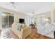 Relaxing living room with tiled floors, sofas, and plenty of natural light at 221 Tenacity Ln, Sarasota, FL 34242