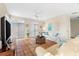 Living room with tiled floors, white couch, and large TV at 221 Tenacity Ln, Sarasota, FL 34242