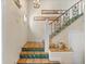 Interior staircase with tile flooring and ornate railing at 221 Tenacity Ln, Sarasota, FL 34242