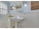 Charming bathroom with pedestal sink and wainscoting at 2338 Lynn St, Sarasota, FL 34231