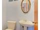 Small half bathroom with pedestal sink and toilet at 2338 Lynn St, Sarasota, FL 34231