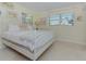 Bedroom with a white metal bed frame and window at 2338 Lynn St, Sarasota, FL 34231