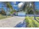 Front view of a light blue house with a paved driveway and landscaping at 2338 Lynn St, Sarasota, FL 34231