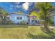 House exterior showcasing a light blue facade, landscaping, and a wooden door at 2338 Lynn St, Sarasota, FL 34231