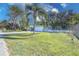 Landscaped front yard with palm trees and a white picket fence at 2338 Lynn St, Sarasota, FL 34231