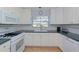 Galley-style kitchen with white cabinets and appliances at 2338 Lynn St, Sarasota, FL 34231