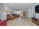 Spacious living area featuring hardwood floors, a brown sectional sofa, and large windows at 2338 Lynn St, Sarasota, FL 34231