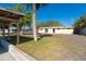 View of backyard, showing house exterior and part of the lawn at 315 Palm Grove Ave, Englewood, FL 34223