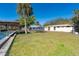 Spacious backyard with canal view and a relaxing hammock under a tree at 315 Palm Grove Ave, Englewood, FL 34223