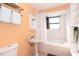 Clean bathroom with pedestal sink and tub at 315 Palm Grove Ave, Englewood, FL 34223