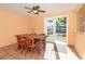 Light-filled dining room with wooden table and chairs near sliding glass doors at 315 Palm Grove Ave, Englewood, FL 34223