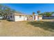 Side view of house showcasing its single-story design and lawn at 315 Palm Grove Ave, Englewood, FL 34223