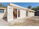 Rear view of house showing access to kitchen and additional storage at 315 Palm Grove Ave, Englewood, FL 34223