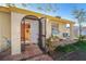 Front entrance with arched screen door and view into the living room at 315 Palm Grove Ave, Englewood, FL 34223